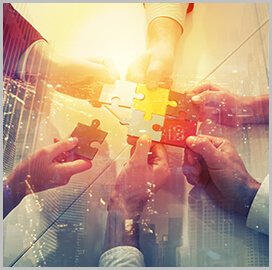 six hands holding puzzle pieces