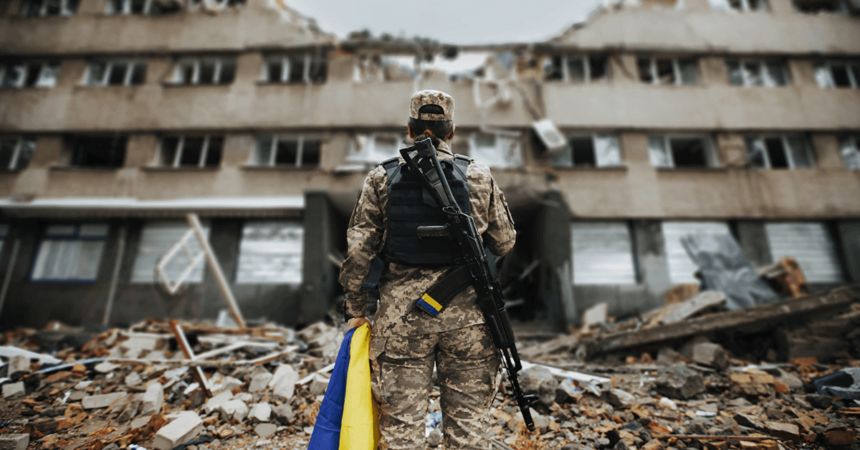 international-conflict soldier standing infront of destroyed building