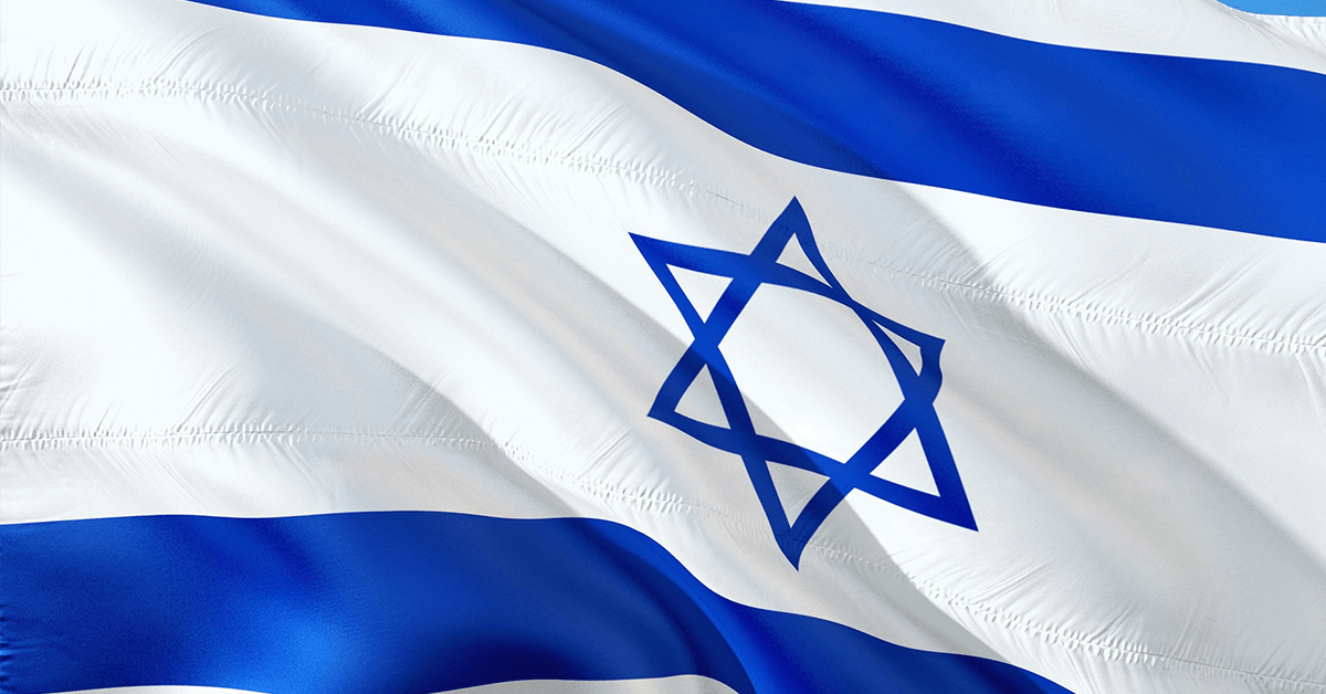 A flying Israeli flag showing a six-pointed star and two horizontal stripes in blue on a white background
